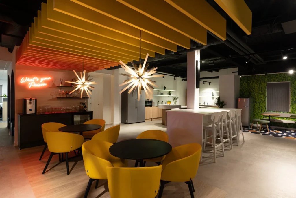 Dining area with warm lighting, tables, chairs and LED signage